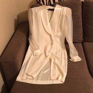 Silk collar, cuffs and buttons. Sheer sleeves. Split to mid thigh.New condition